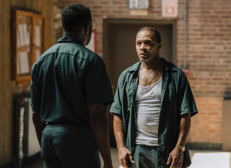 Clarence Maclin grimaces in a prison gymnasium. 