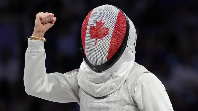 A fencer pumps her fist.