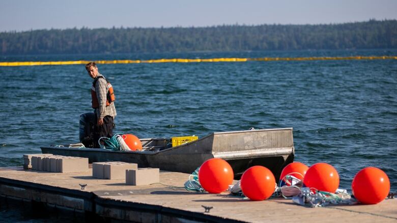 Marina construction specialist Mark Kunyckyj helps deploy the curtain at Clear Lake's Boat Cove.