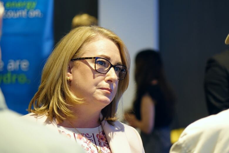 Jennifer Williams, wearing glasses, listens to a participant of the N.L. Hydro AGM.