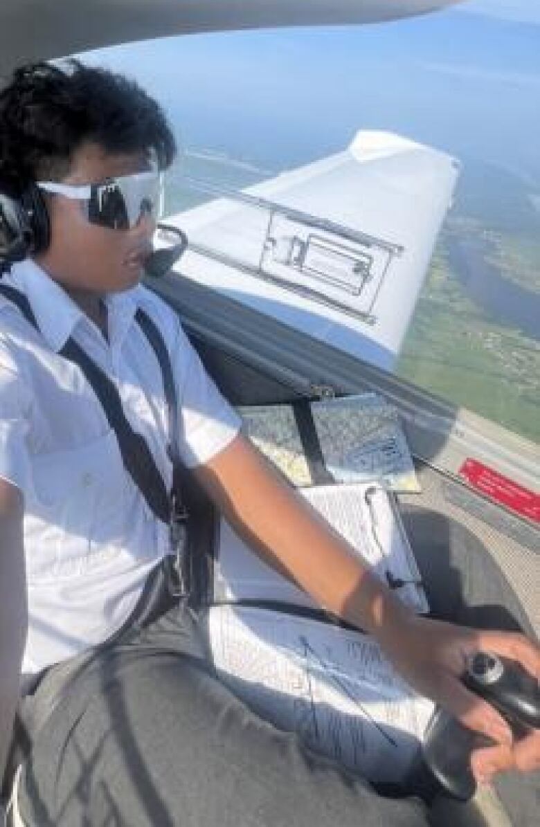 Miguel Vincent Mina Estrada flies in the cockpit of an airplane.