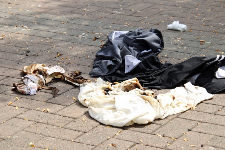 A pile of burnt clothing on the ground