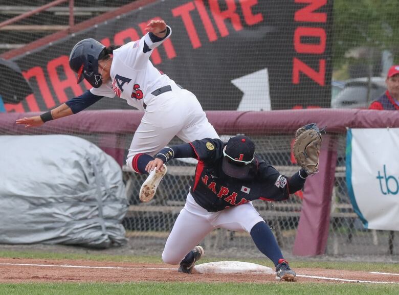 An action shot of two baseball players colliding during a game .