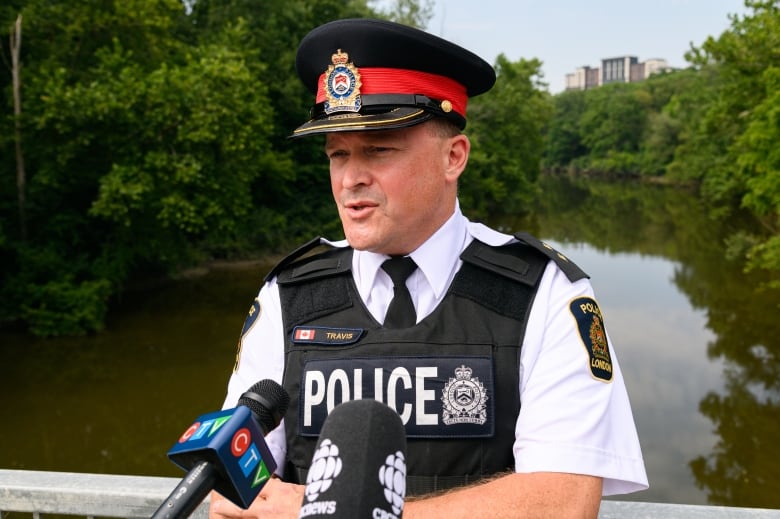 Insp. Sean Travis of the London Police Service speaks with media on University Drive Bridge in London, Ont. on Aug. 4, 2024, a short distance downstream from where the body of seven-year-old Anna Bielli was located by search crews. 