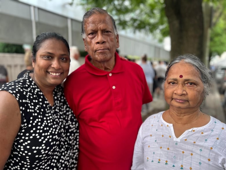 Three people pose for a photo