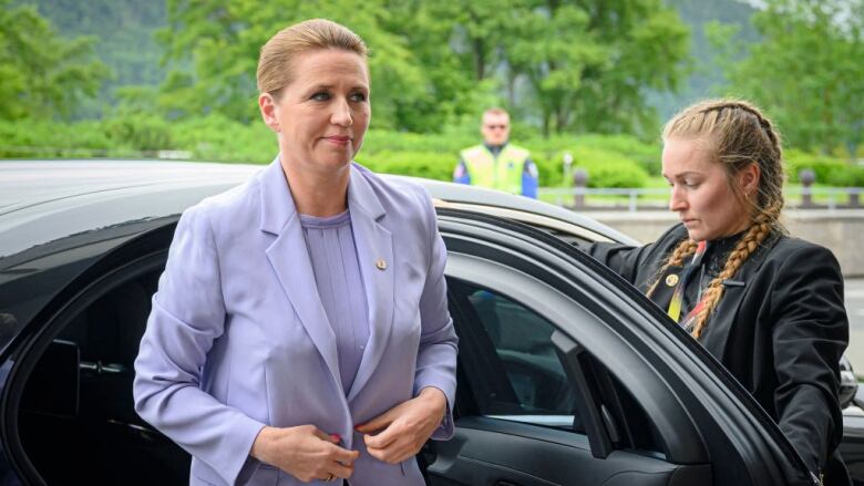 Denmark's Prime Minister Mette Frederiksen gets out of a car.