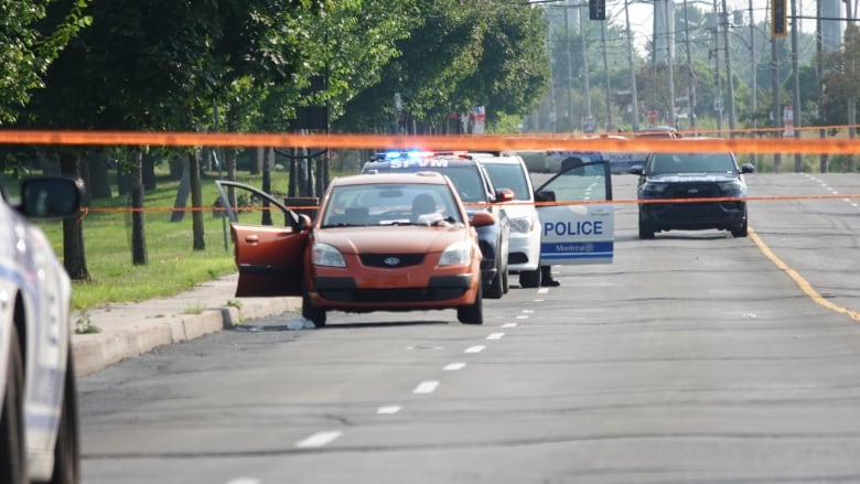 Police tape around a vehicle.