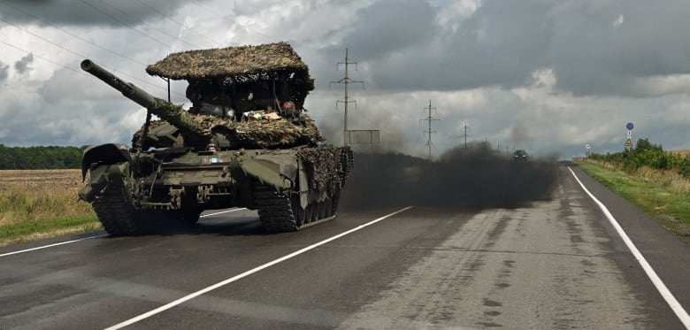 A Russian tank is seen driving near the town of Sudzha, in Russia's Kursk region, on Thursday.