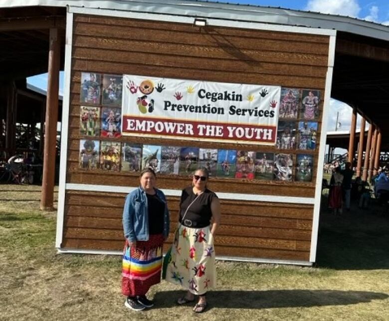 2 women in front of a powwow arbour