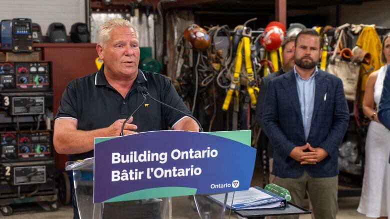 A man stands at a podium and speaks. 