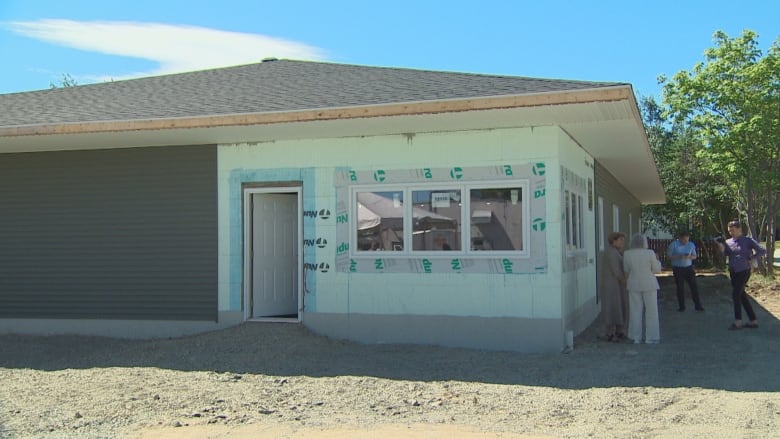 House like building without siding in construction zone.