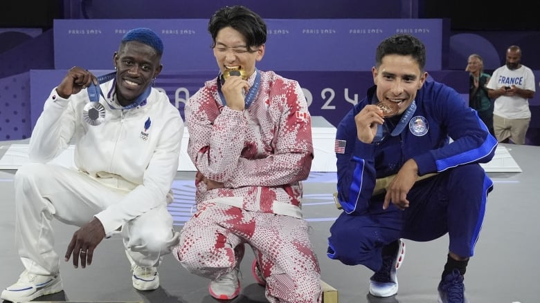 Three breakers are seen posing with their medals.