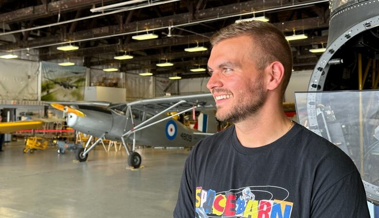 A man in an aircraft hangar.