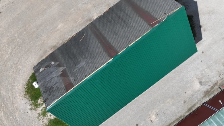 Metal roofing was lost and thrown downwind but the old asphalt roof remained of a structure in New Scotland, Ont.