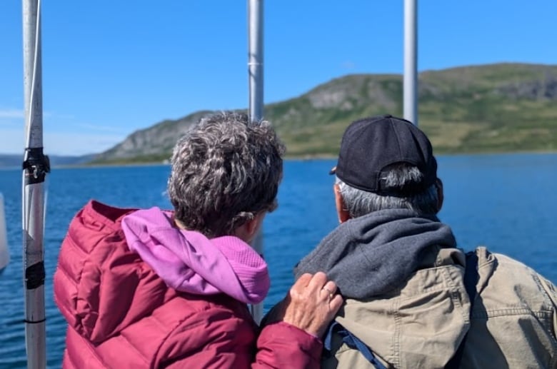 Two Inuit elders look into distance from the ship.