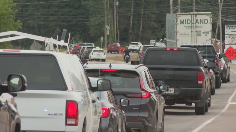 Cars are lined up in traffic.