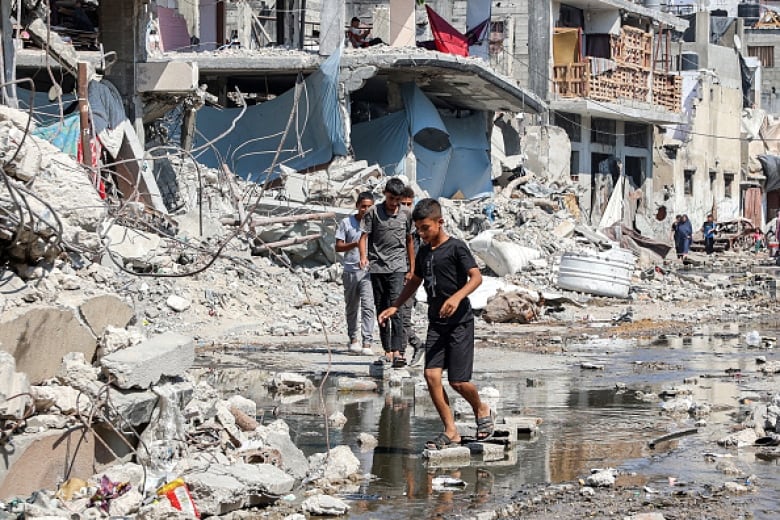 Boys walk in rubble in the northern Gaza Strip.