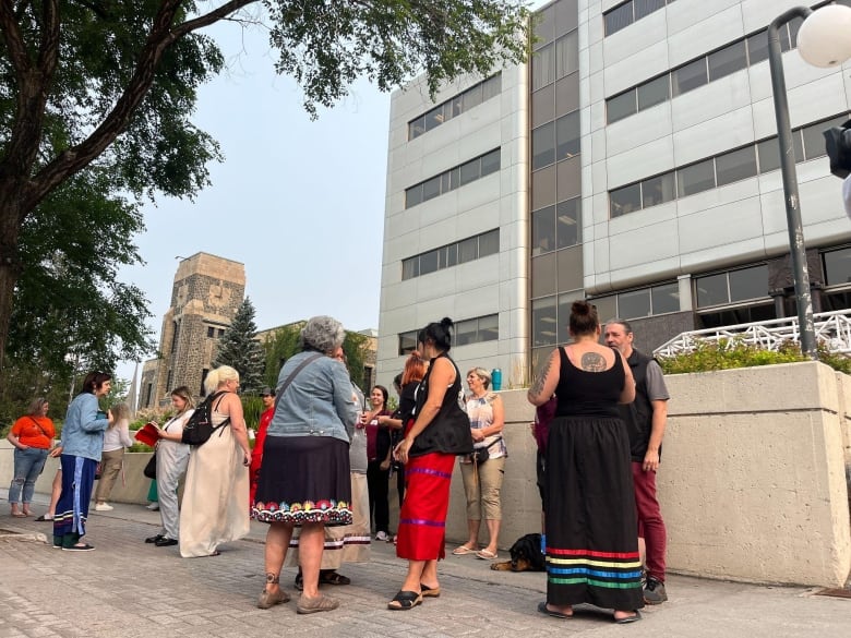 A group of people gather outside the courthouse