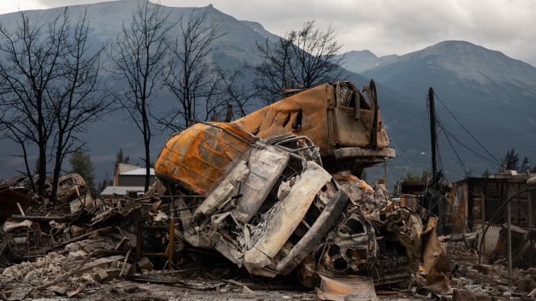 A small pile of burnt cars in Jasper, Alta., on Friday, July 26, 2024. Wildfires encroaching on the townsite forced an evacuation of the national park and destroyed more than 300 of the town's approximately 1,100 structures, mainly in residential areas.