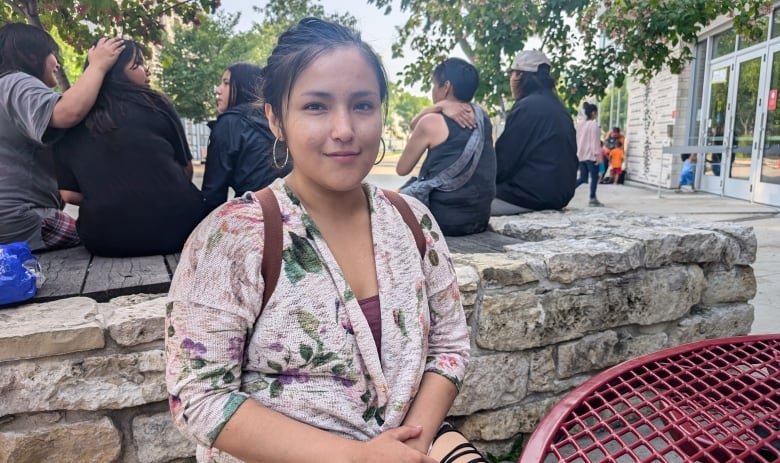 A woman posing for a picture outdoors.