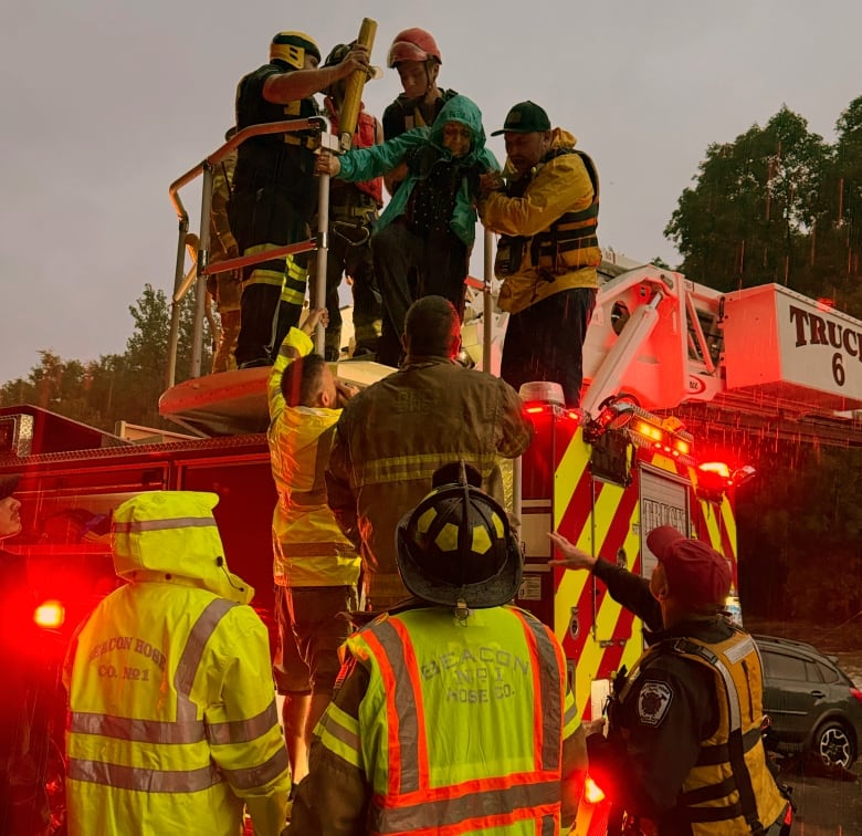 Firefighters gather during extreme flooding.