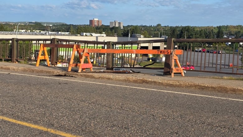 A damaged section of guardrail on a bridge.