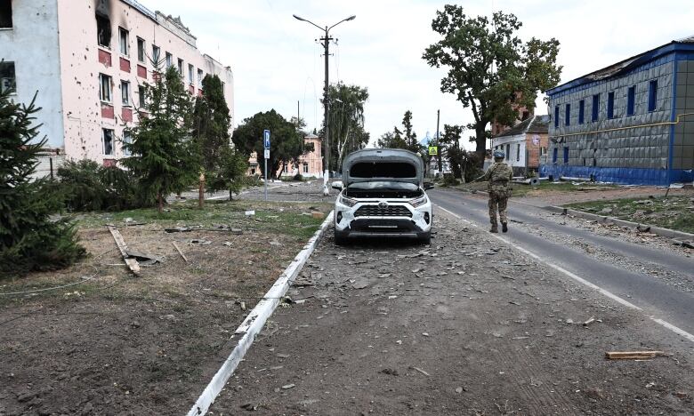 A Ukrainian soldier patrols a street in a Ukrainian-controlled part of Sudzha, a Russian town in the Kursk region, during a media tour last Friday.