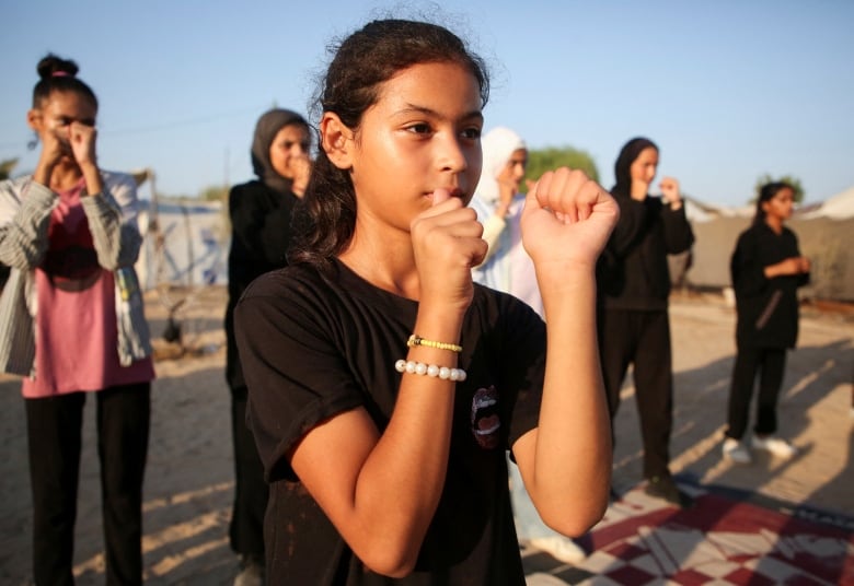 a group of girls line up for boxing class