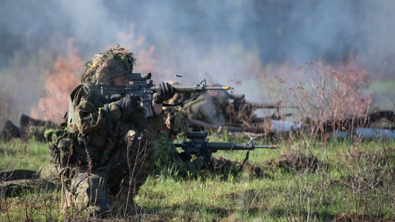 Soldiers with rifles in their hands during a combat