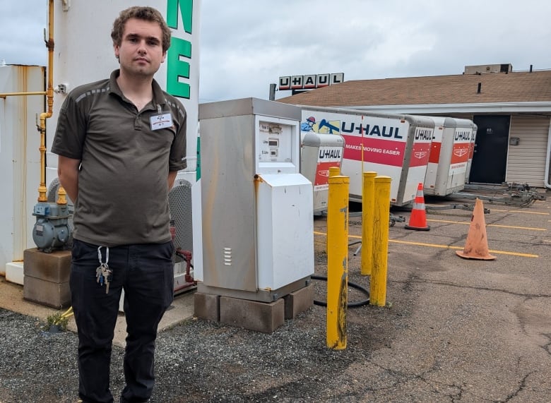 Kyle Richard stands in front of a propane tank.