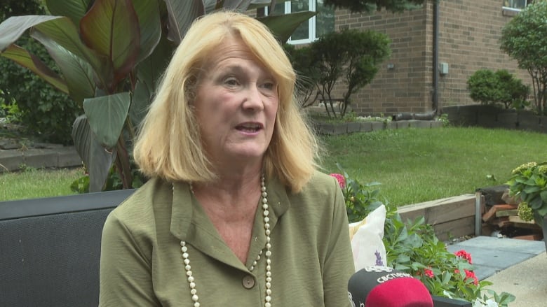 A woman speaks into a CBC microphone.