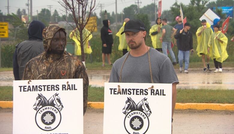 Union members picket outside a rail yard