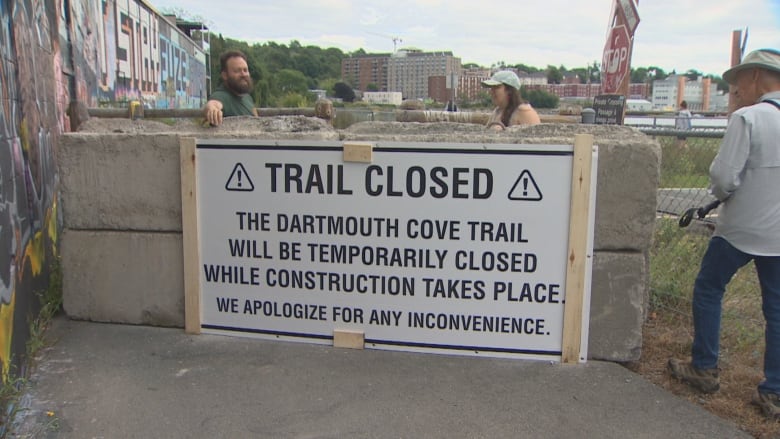 concrete block barriers with sign on front saying the trail was closed.