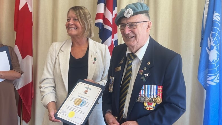 Mary Wilson, Minister responsible for military affairs, presented a certificate of the Nobel Pace Prize to U.N. Peacekeeper Douglas Cosman in Saint John.