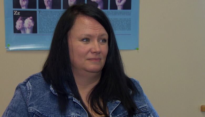 Woman with black hair and denim jacket. 