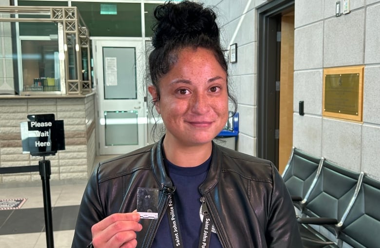 A lady holding a fingerprint in her hand.