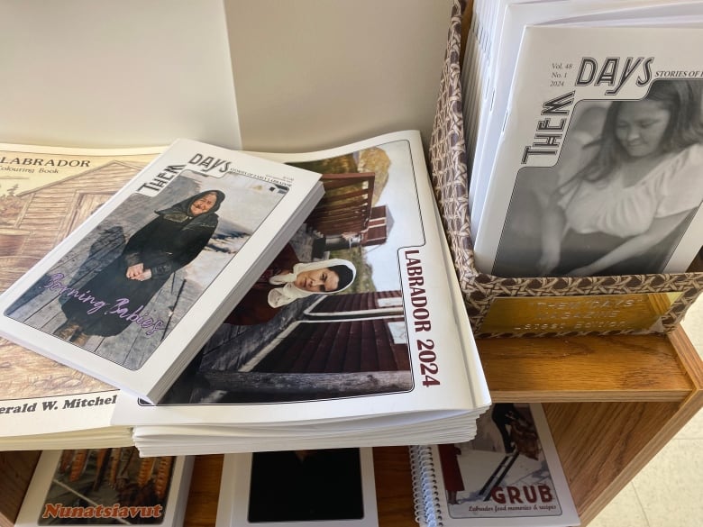 Stack of magazines on a shelf.