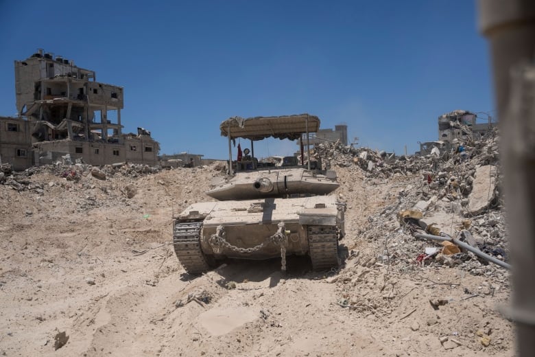 A view of an Israeli tank seen next to destroyed buildings in the southern Gaza strip. 