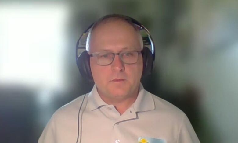 A man with a headset on zoom