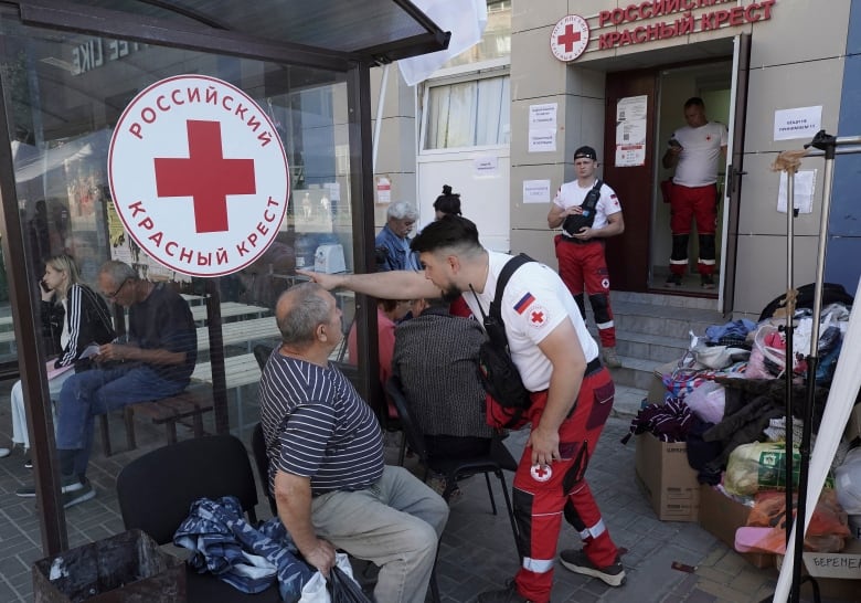 War-displaced people receive humanitarian aid at a Russian Red Cross distribution point in Kursk on August 15, 2024, following Ukraine's offensive into Russia's western Kursk region.