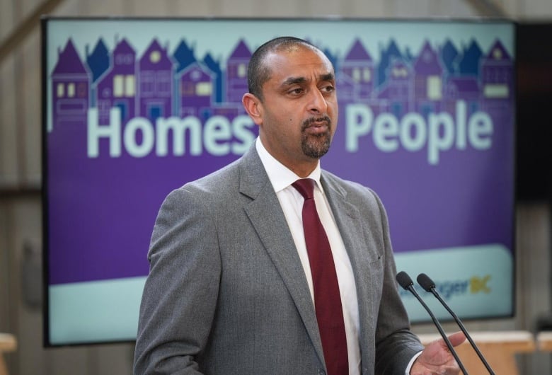 A man speaks at a podium.