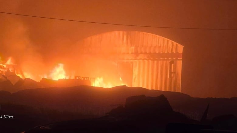 Orange flames in a dark photo around a co-op store in Nunavut