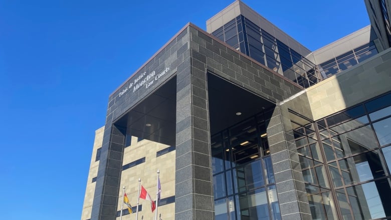 the front entrance of a large courthouse and a blue sky