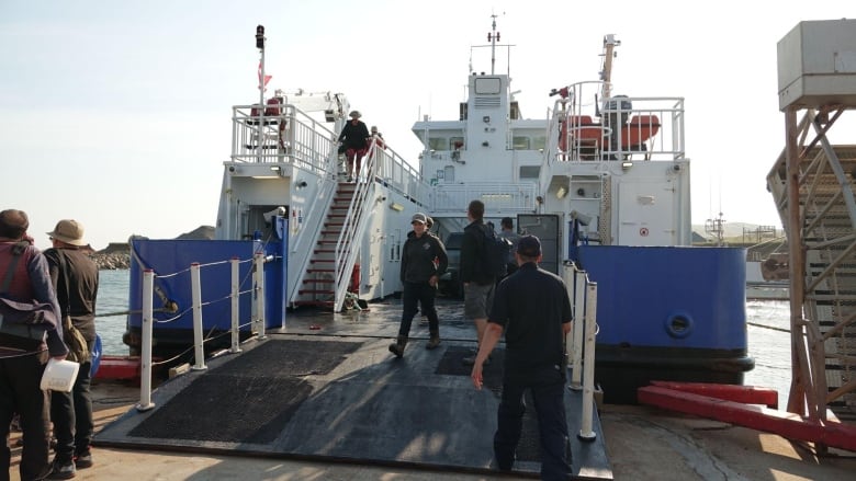 Ferry undocks at an island.