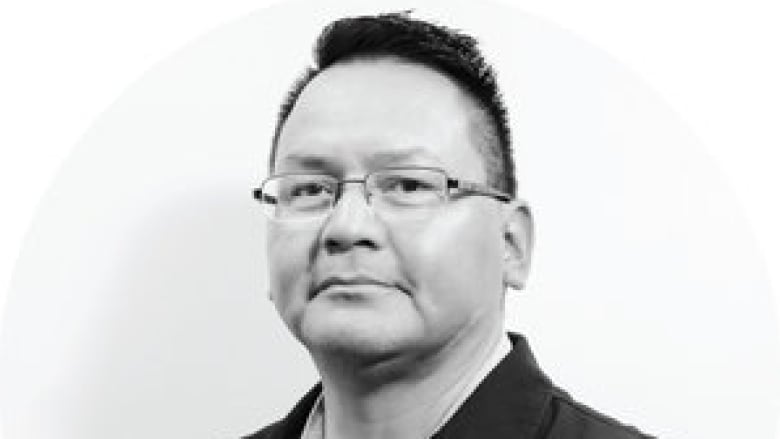 An Indigenous man is pictured in a black-and-white headshot.