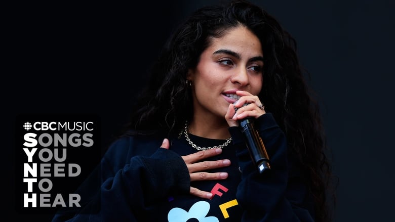 A closely cropped image of Jessie Reyez (a Latine woman) performing on stage. The CBC Music logo and the words: Songs You Need to Hear, appear in the lower right hand corner of the image. 