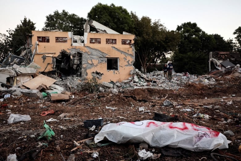 A dead body lies on the ground following a mass infiltration by Hamas gunmen from the Gaza Strip, in Kibbutz Beeri in southern Israel, October 11, 2023.