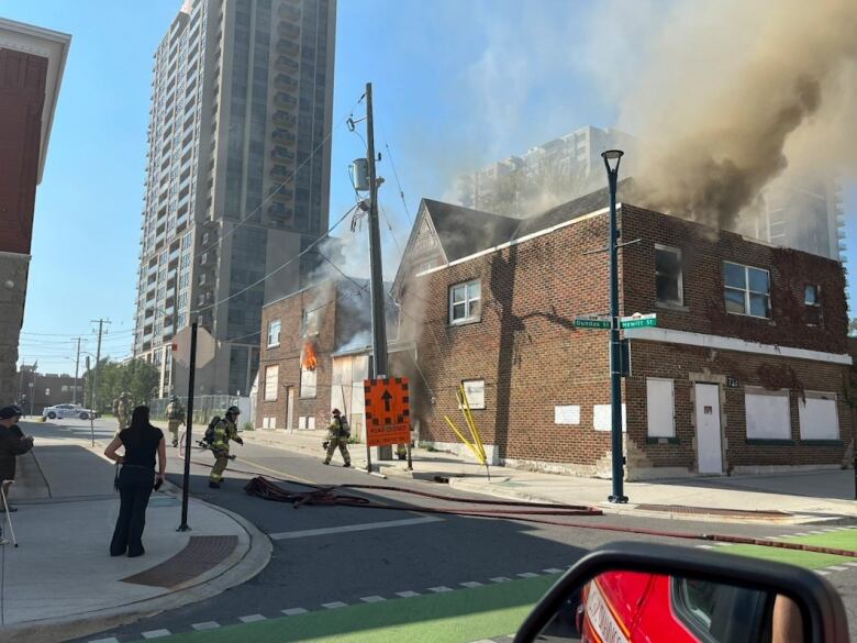 A building at the corner of Hewitt and Dundas streets billowing smoke on Thursday.