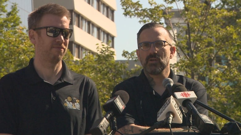 Two men stand at a podium