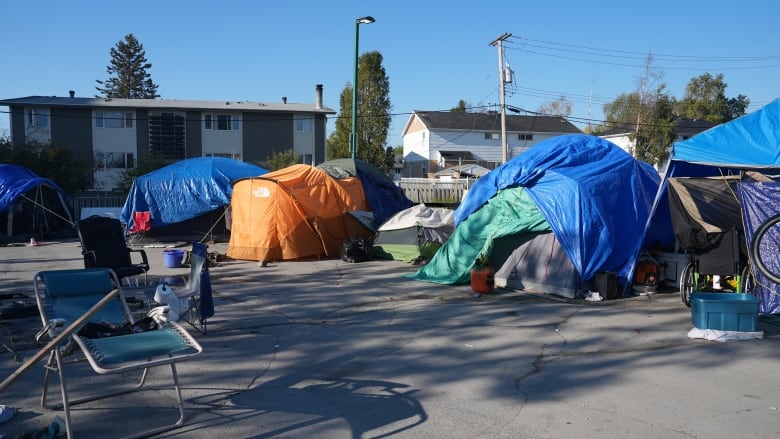 Tents and chairs in a parking lot.